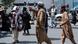 A Taliban fighter talk to a woman, to disperse Afghan women protesters, in Kabul, on August 13, 2022. 