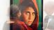 In this picture a woman is looking at the photo 'Afghan Girl' (Pakistan, 1984) during the exhibition 'Steve McCurry Retrospective' of the US photographer at Kunsthalle in Erfurt, Germany